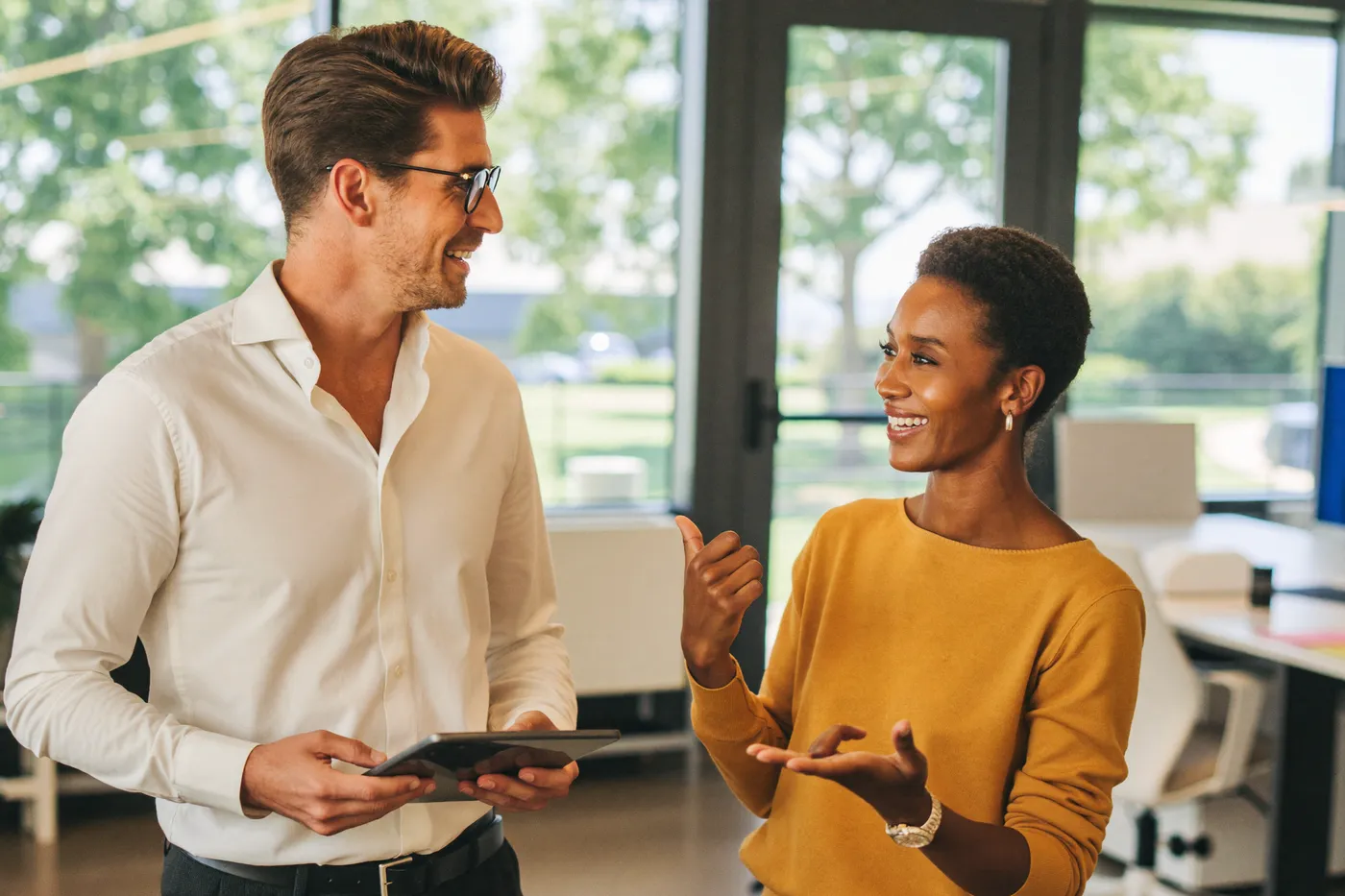 Two colleagues in conversation in an office