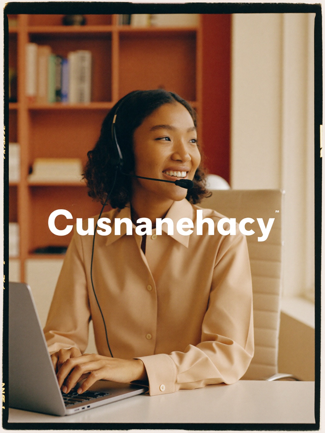 A friendly support specialist wearing a headset, smiling mid-conversation at a bright desk