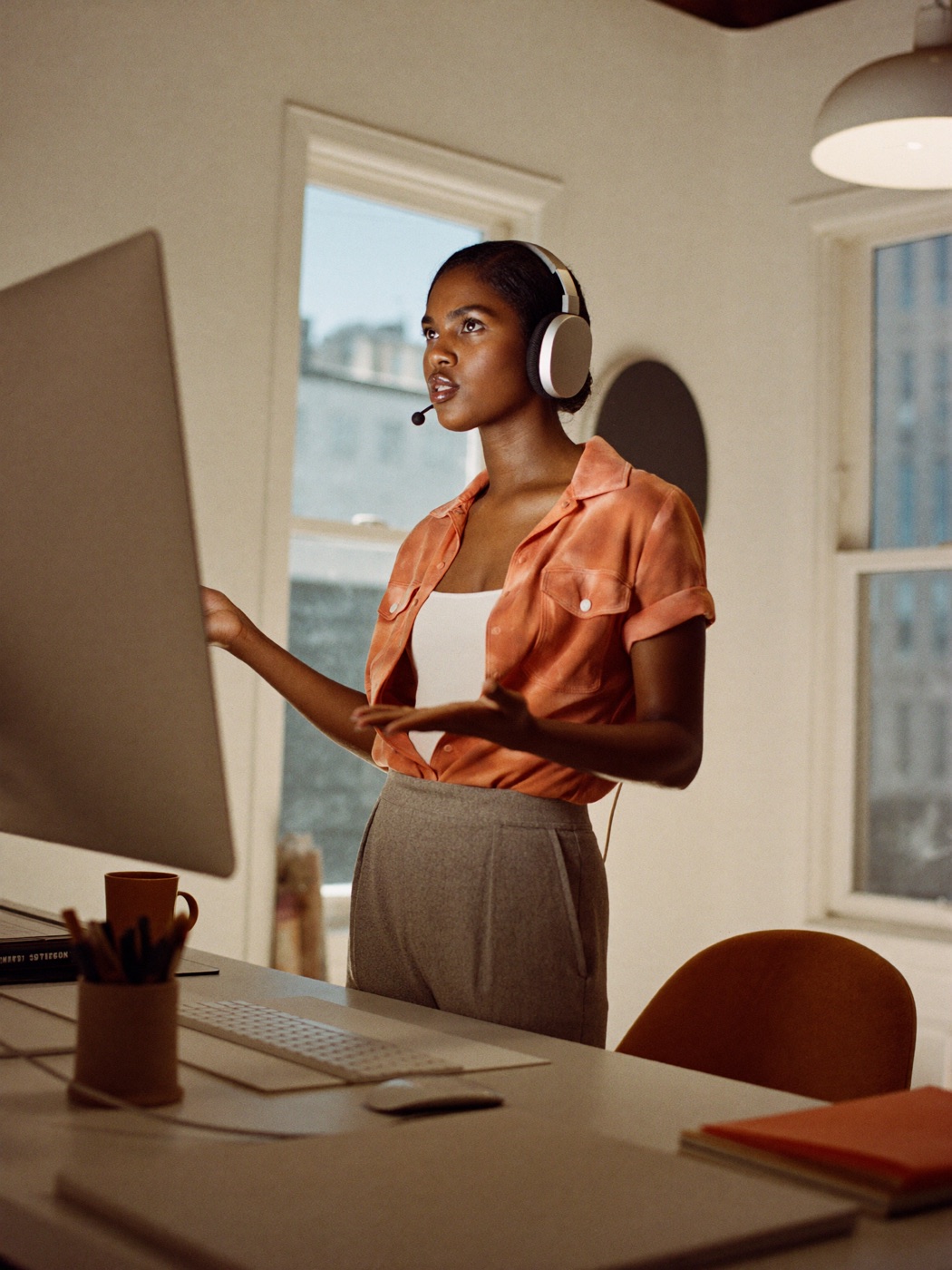 A confident sales professional mid video call, gesturing while talking